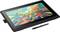 A graphics tablet with a colourful digital artwork displayed on the screen. A stylus lies beside it, ready for use.