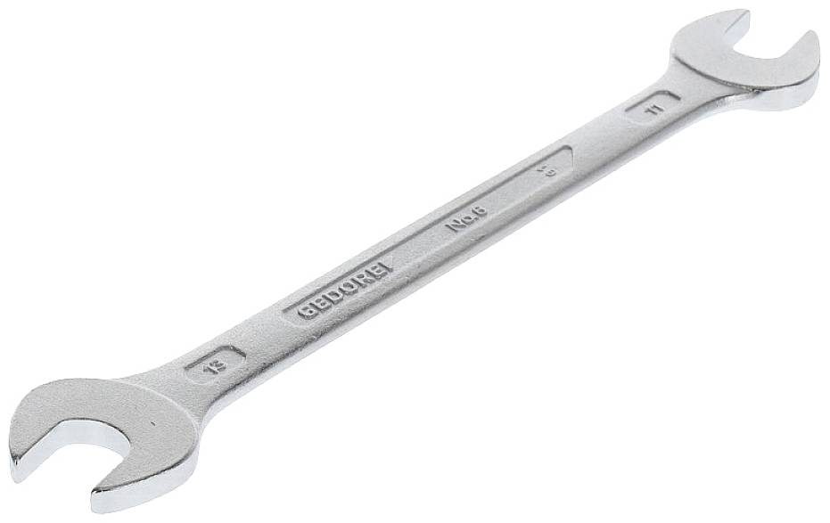 A silver adjustable spanner with size markings of 12 and 13 mm, resting on a light surface.