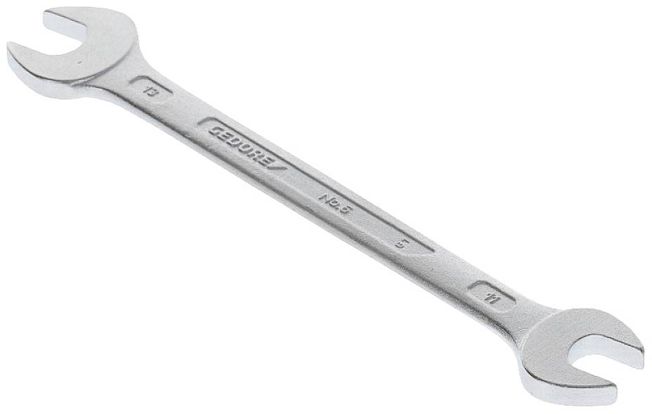 A silver adjustable spanner lying on a white background, with different sized ends.