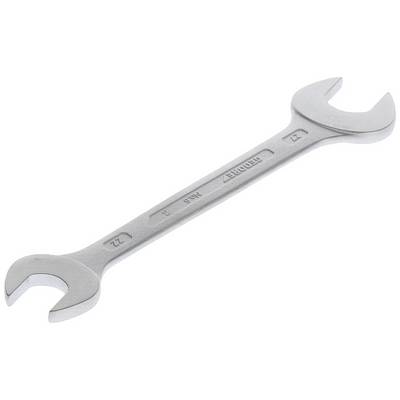 A silver adjustable spanner lies at an angle. One side is marked with '22', the other with '19'.
