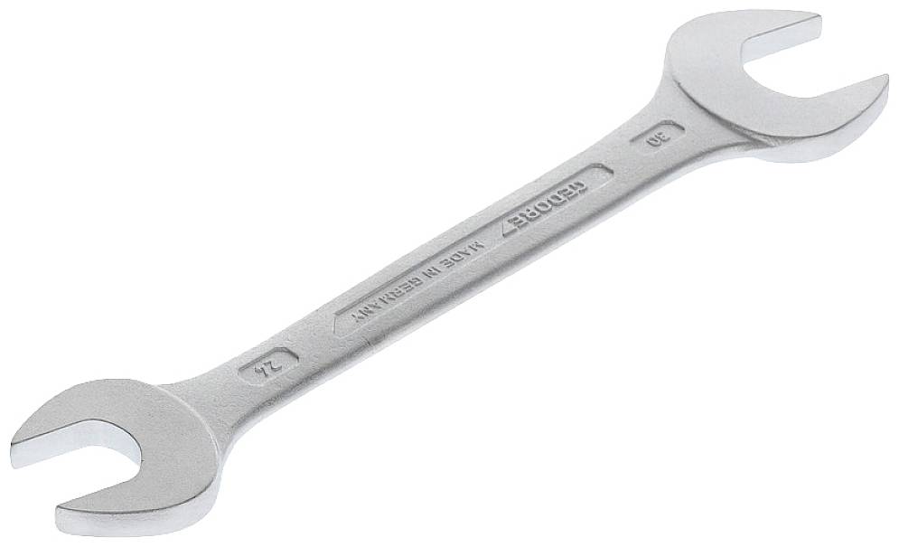 A silver-gleaming spanner with two different jaw sizes at its ends, lying on a neutral background.