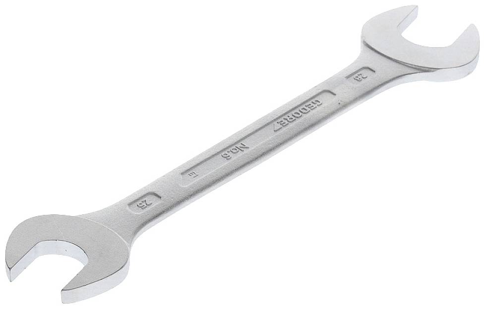 A silver adjustable spanner with two ends of different sizes, lying on a flat surface.