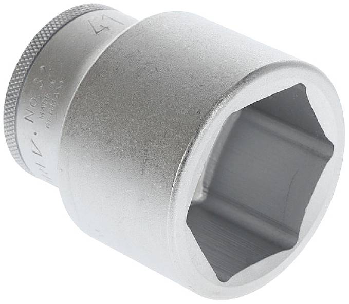 A silver hexagonal socket, a tool for screw work, is lying at an angle on a light surface. It has a smooth, shiny surface.