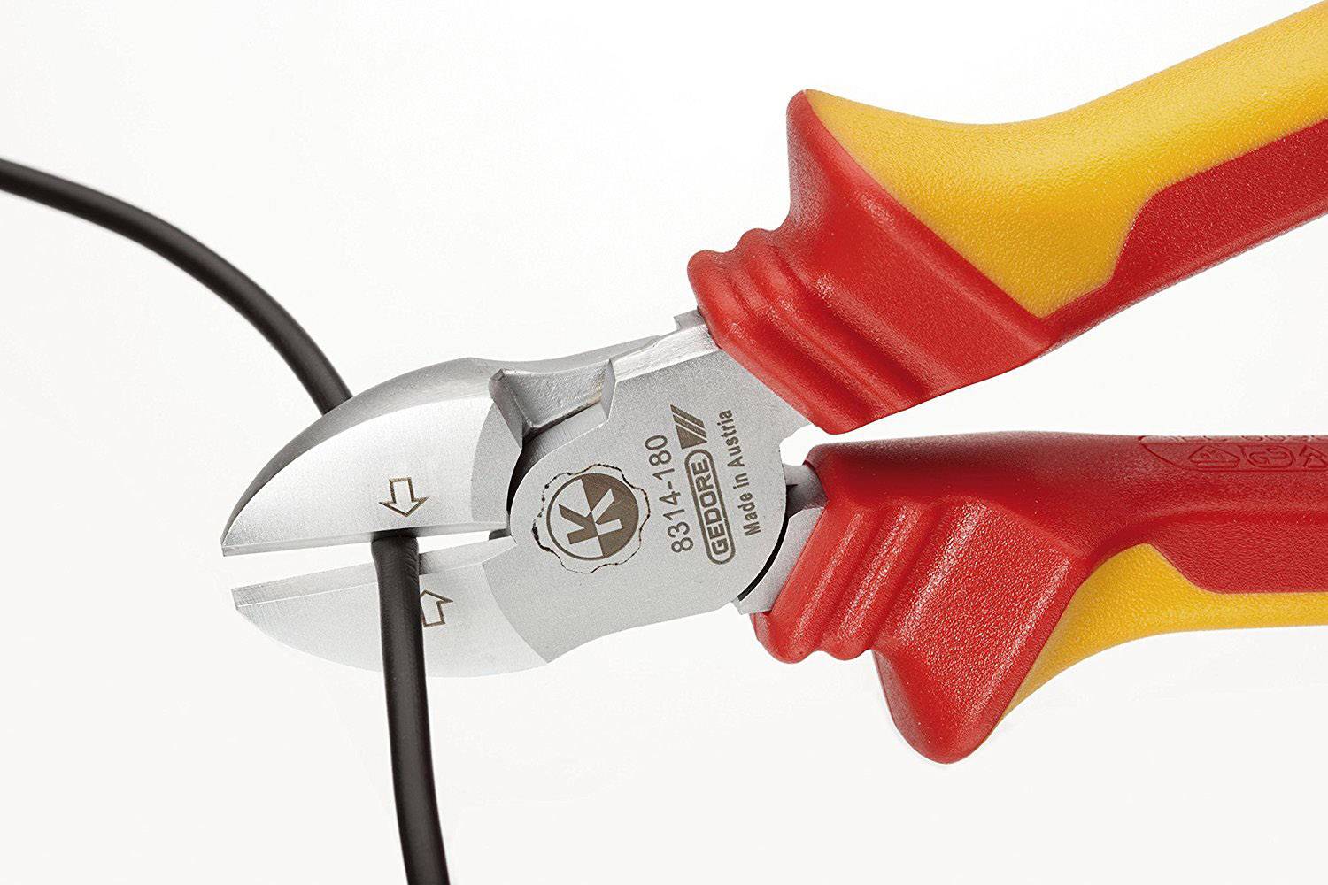 Side cutters with red and yellow handles are cutting a black cable.