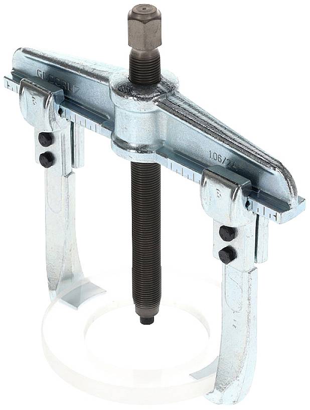 A three-way adjustable metal puller, used for removing bearings or gears, shows a central screw mechanism.