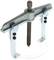 A silver two-arm puller with a central screw, used for removing gears or bearings.