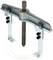 Industrial two-arm puller with a central screw for removing stuck parts from axles or shafts in mechanical applications.
