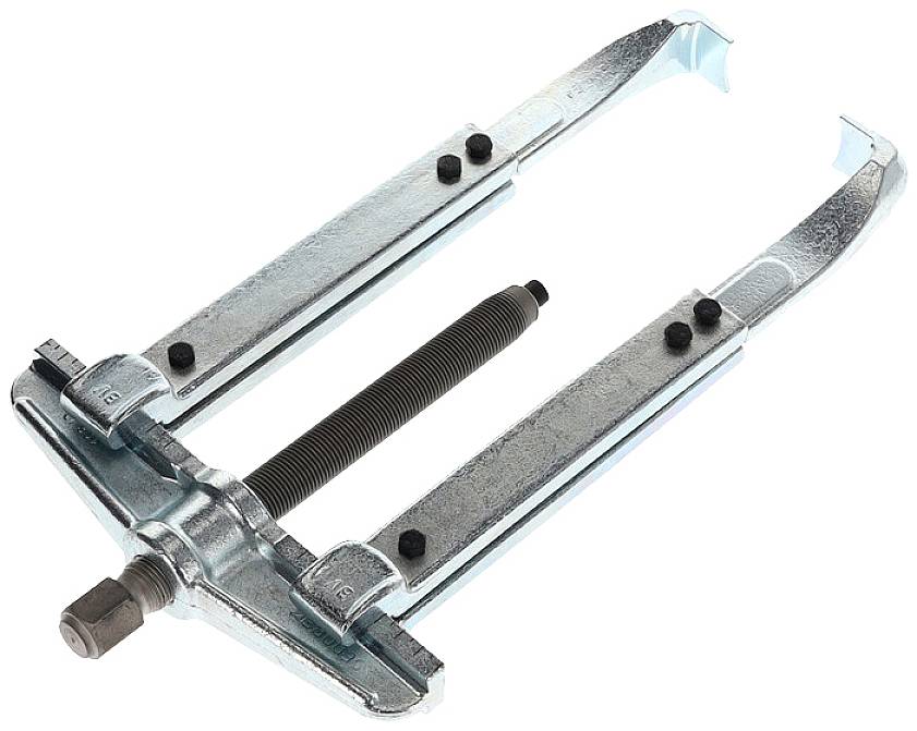 A metallic two-arm puller with a central bolt and a handle. Used for removing parts from shafts.