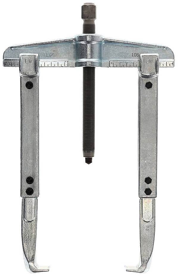 A two-arm metal puller with a central bolt, used for removing bearings or gears, stands upright.