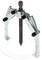 A three-armed metallic puller with a central screw, used for removing ball bearings or similar components.