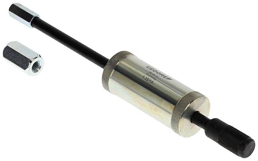 A power impact driver tool with a cylindrical metal body and black shaft, partially disassembled with a hexagonal nut beside it.