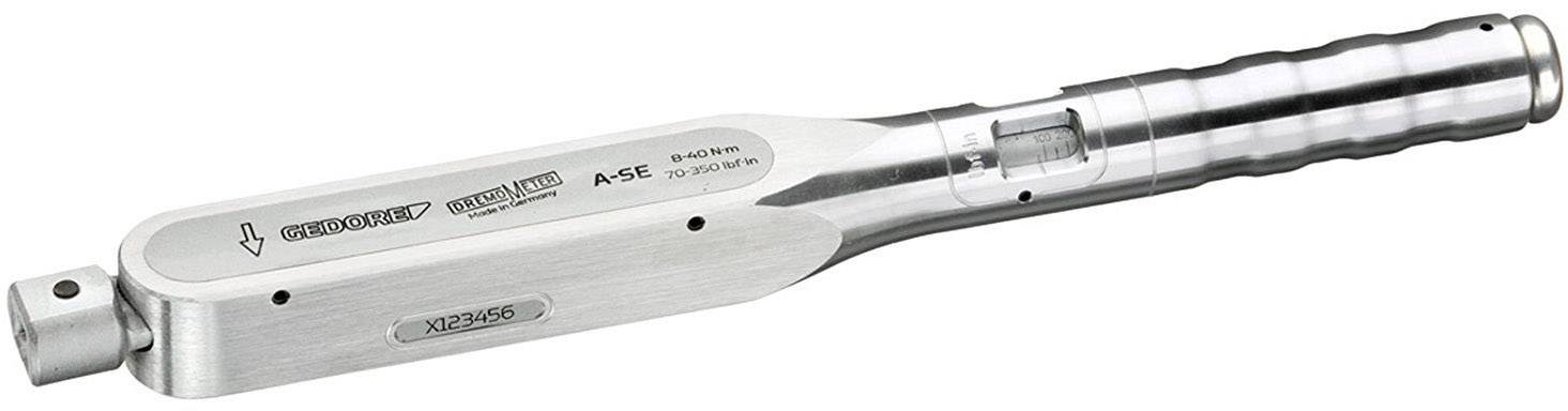 A silver torque wrench with engraved markings and an adjustment window for displaying the torque setting.