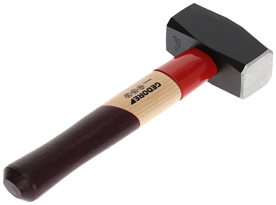 A black hammer with a red and wooden handle lies on a white surface.