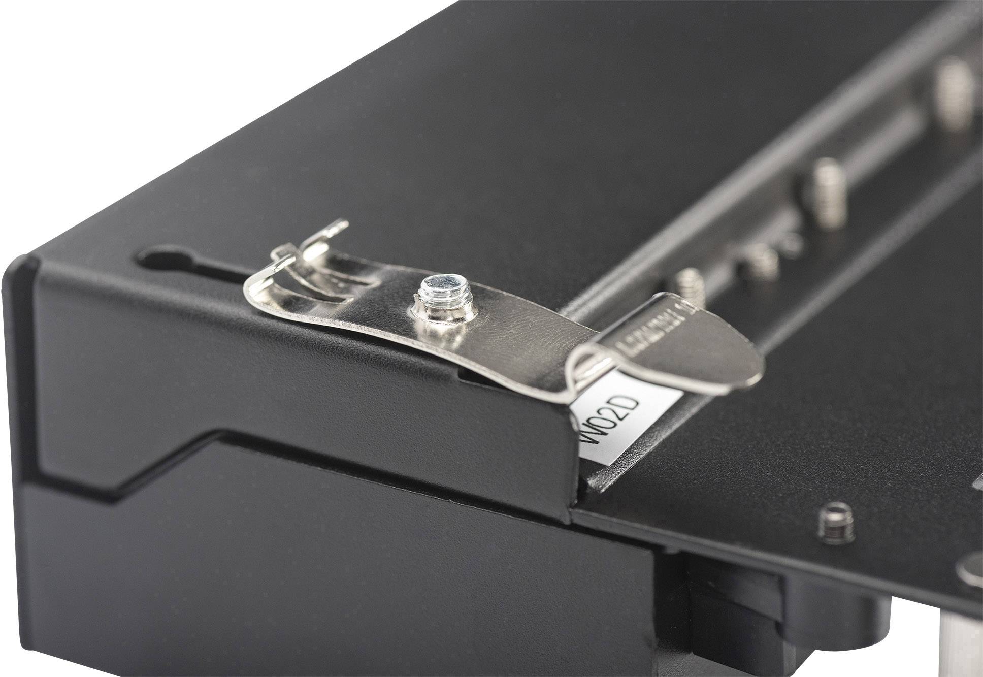 A hole punch reinforcer on a black folder shows a list or label.