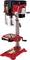 Pillar drill in red with control elements and protective cover. Adjustable table and side-mounted handle. Tool for precision drilling.