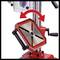 A metal drilling table with a rotatable surface, indicated by a red arrow. The surface can be tilted to alter the angle.