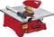 Red table saw with yellow saw blade, equipped with a fence and safety guard. It is used for precise wood cutting.