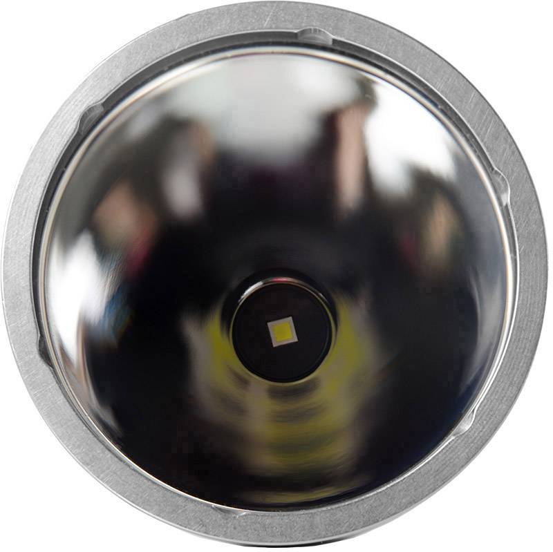 Metallic, reflective surface of a torch, with an LED situated in its centre.
