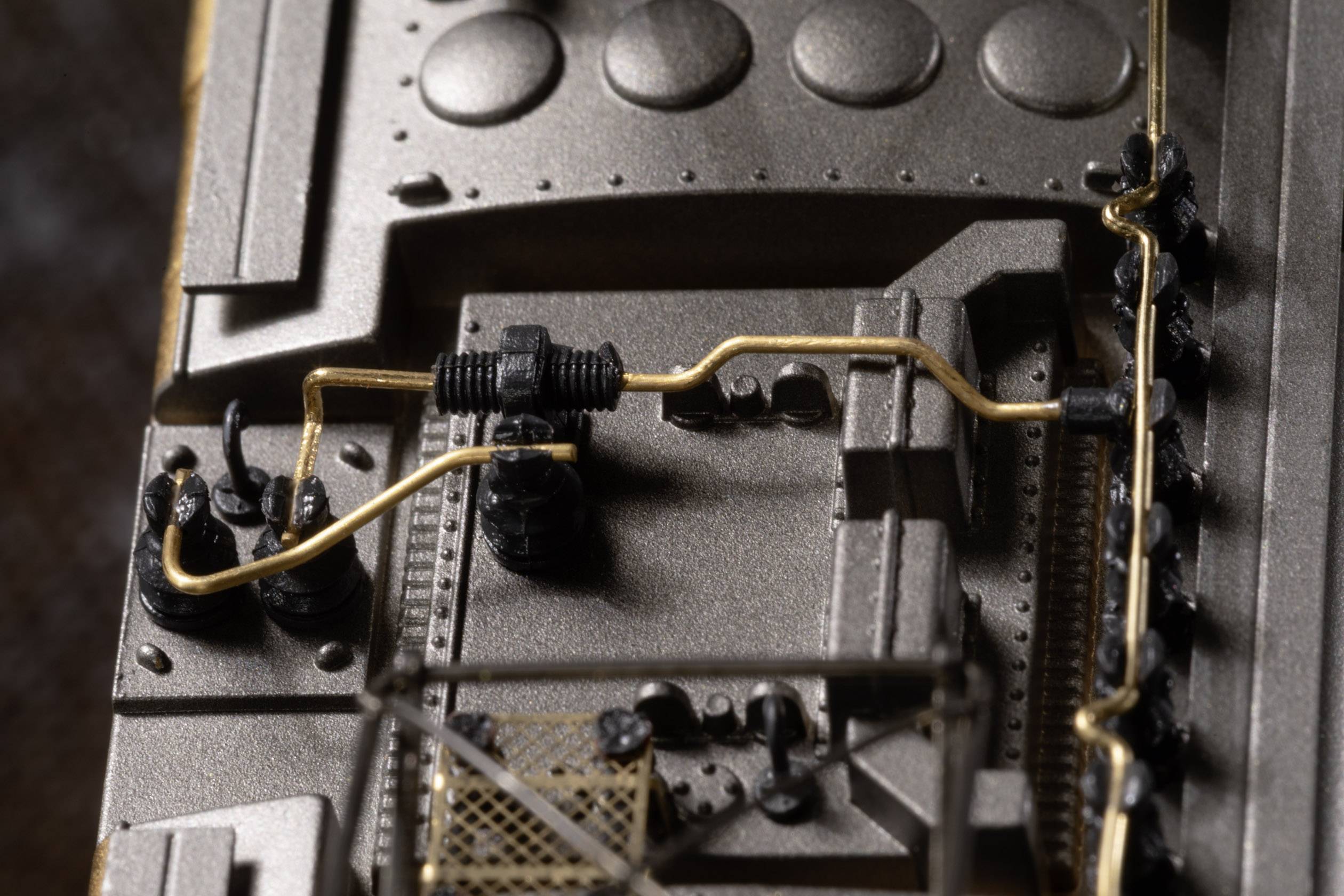 Detailed close-up of a technical apparatus with pipes and valves mounted on a metal surface.