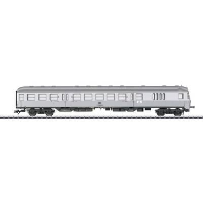 Grey railway carriage on tracks, side view. The carriage has multiple windows and is designed as a passenger train compartment.