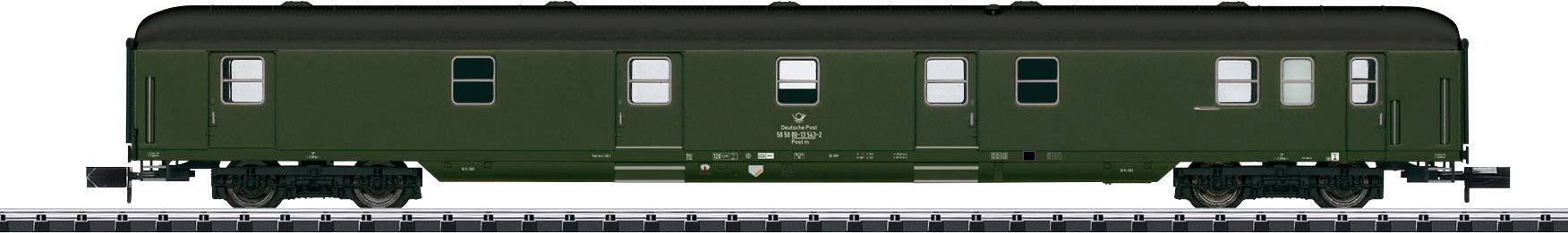 Green rail carriage in a historical style on a track, with multiple windows, painted dark green, side view.
