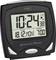 Digital alarm clock showing '10:24' and '18.12. MON', alarm set to '7:00'. Buttons for alarm setting, black casing.