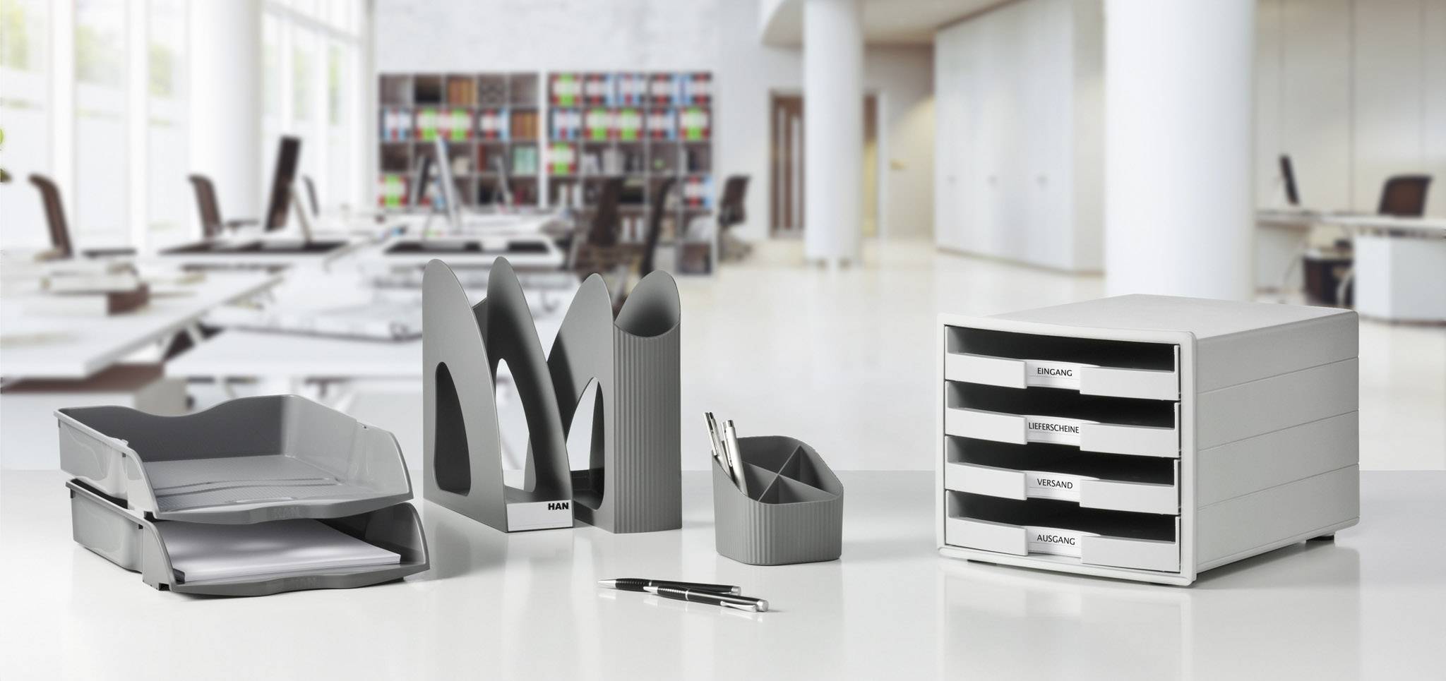 Plastic office organisational set in a modern design with storage compartments, file holders, and a drawer box, positioned in an office setting.