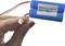 A hand is holding two blue lithium-ion batteries, marked with '18650 lithium batteries' and 'Capacity: 1500mAh', next to a connector.