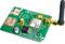 A green electronic circuit board with a SIM card slot, antenna, and multiple chips, used in telecommunications.