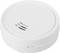 Round white smoke detector with ventilation slots on one side.
