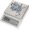 A digital kitchen scales shows a weight of 27 grams. On the scales lies a pile of metal bolts and screws.