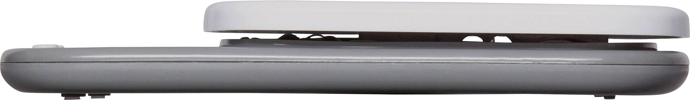 The image shows a side view of a folded laptop with a grey underside and light-coloured top.