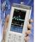 A hand is holding a spectrum analyser device displaying a frequency diagram. Mobile phone masts are visible in the background.