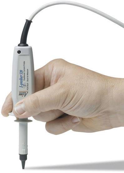 A hand is holding an electrical measuring probe with a cable. The probe is used for precise measurements and testing of electronic devices.