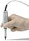 A hand is holding an electrical measuring probe with a cable. The probe is used for precise measurements and testing of electronic devices.