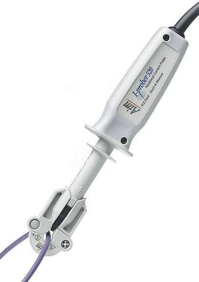 An electronic measuring device with a probe and insulated cables, likely used for capturing electrical signals.