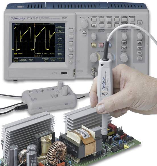 'An oscilloscope shows a signal diagram with a probe checking a circuit board. Electronic components are visible.'