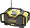Portable yellow construction site radio with large speaker and antenna, display showing station information. Brand visible at the front.