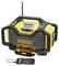 A yellow and black construction site radio with a robust casing, antenna, and docked smartphone. Suitable for outdoor use.