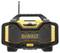 Black and yellow portable radio with large speaker grille, handle on top and aerial.