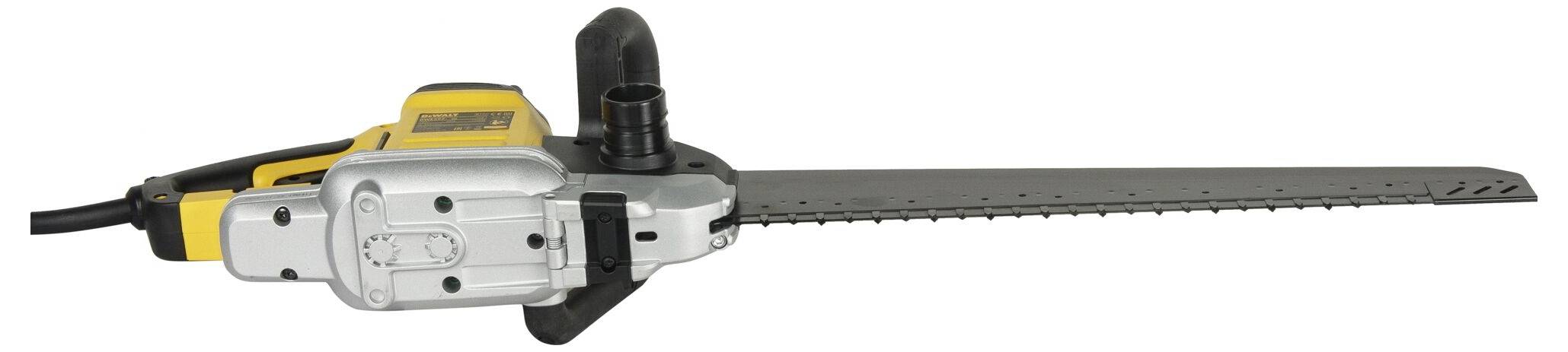 An electric hedge trimmer with a black cutting blade and yellow casing, lying on a white surface.