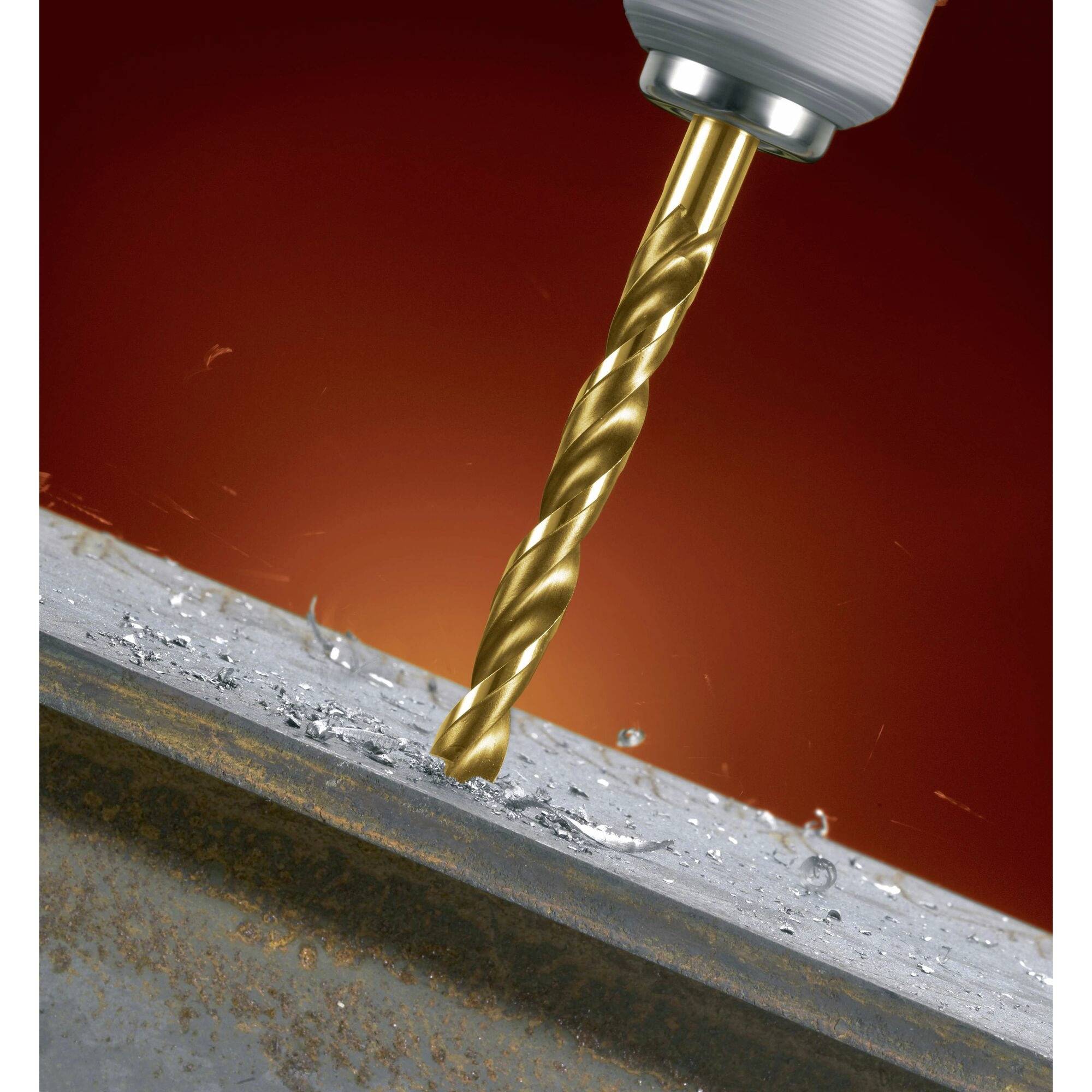 A gold-coloured drill bit penetrates a metal surface, surrounded by sparks against a red background.