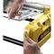 A person is installing the yellow protective cover of an electric circular saw.
