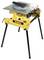 Yellow tabletop circular saw on a stand. The device has a silver work surface and is from the Dewalt brand.