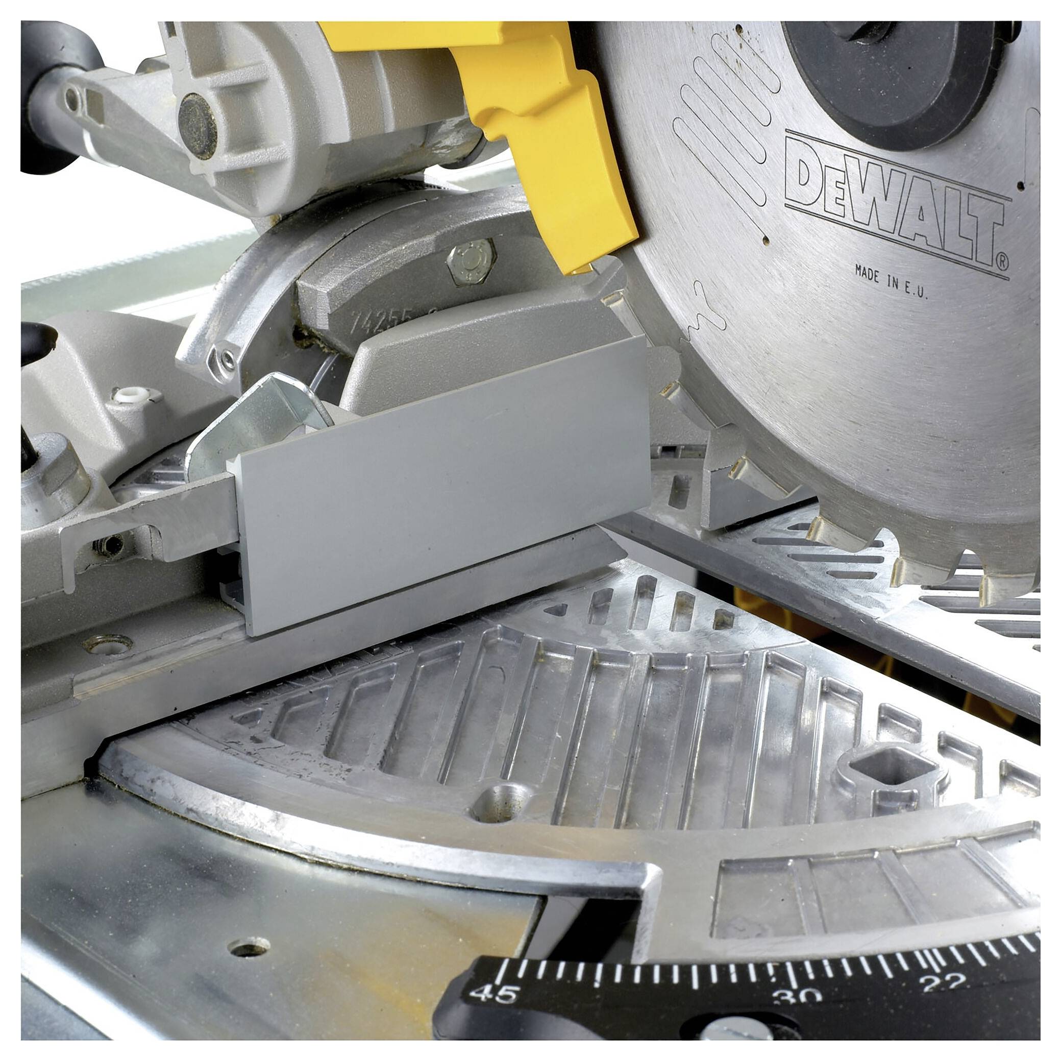 A DeWalt electric mitre saw with a metal saw blade and a yellow guard, prepared for precise cutting work.