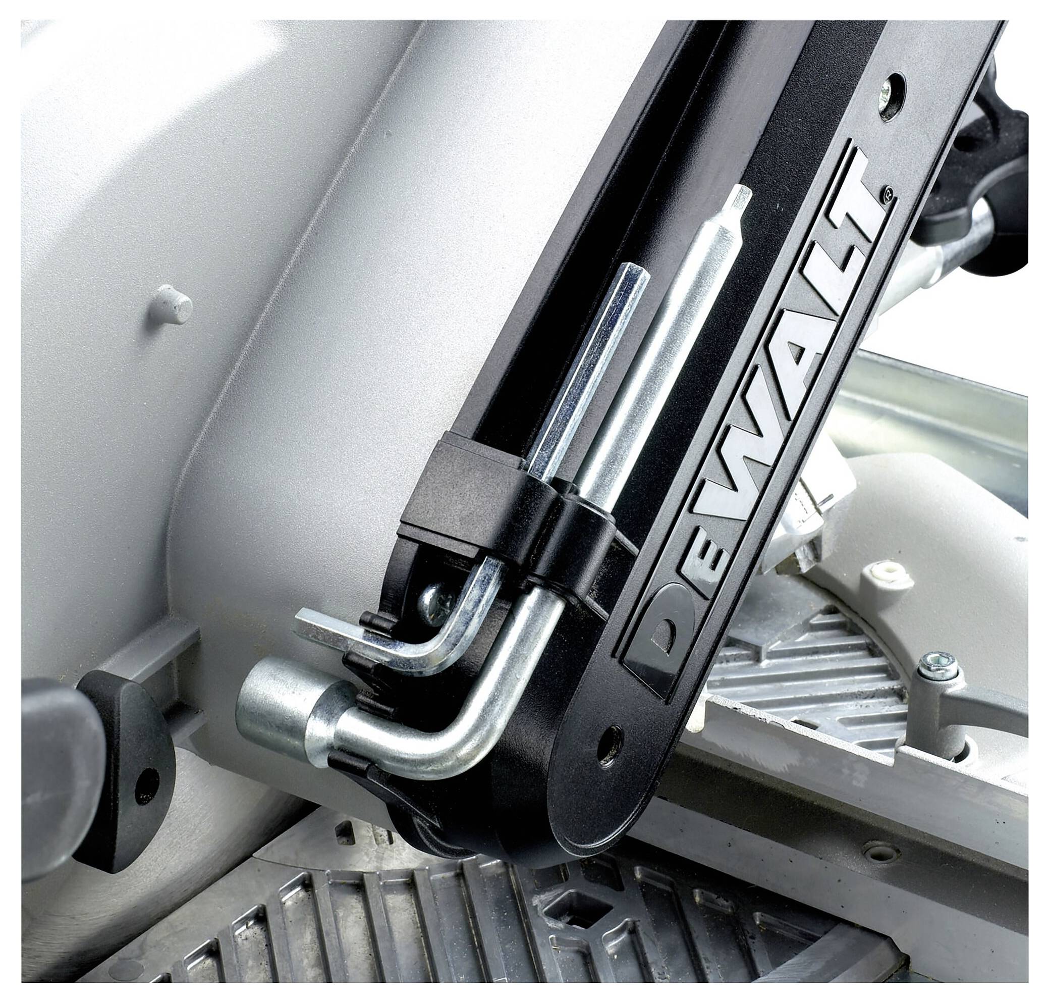 Circular saw blade of an electric machine with DeWalt logo in focus. Metal parts and finely detailed mechanics visible.