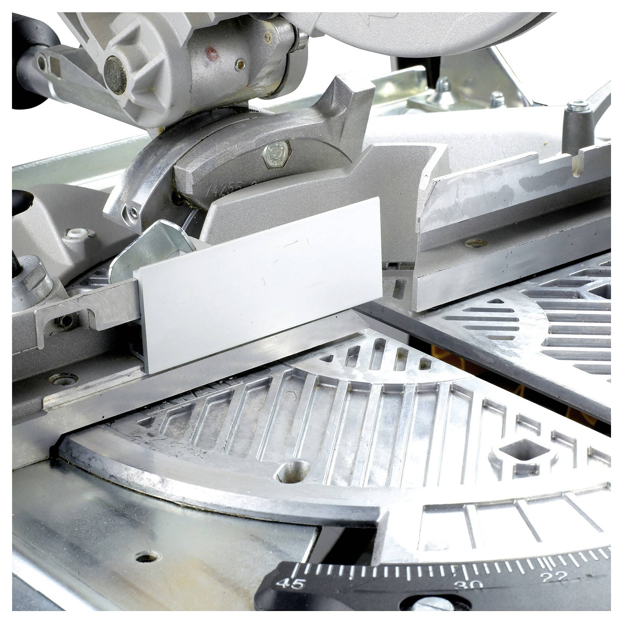 A mitre saw with a metal guide rail and measuring scale. It is mounted on a metal table with angle gauges for precise woodworking and metalworking.