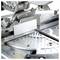 A mitre saw with a metal guide rail and measuring scale. It is mounted on a metal table with angle gauges for precise woodworking and metalworking.