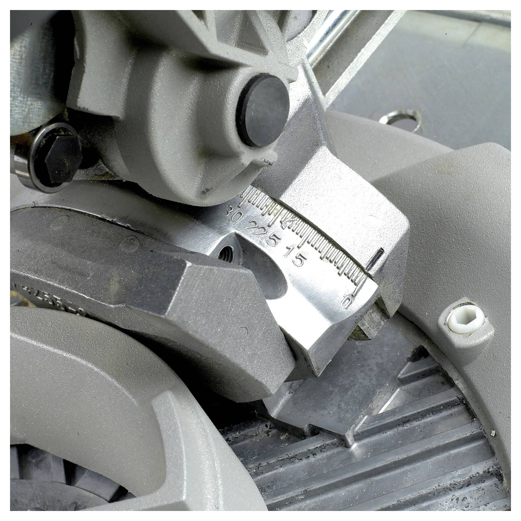 Close-up of an adjustable metal tool. A scale with numerical markings is visible, enabling precise adjustment.