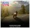 A motorbike rides along a winding mountain road at sunset. Above it is the 'Liqui Moly' logo and the text 'prevents black sludge - high wear protection'.